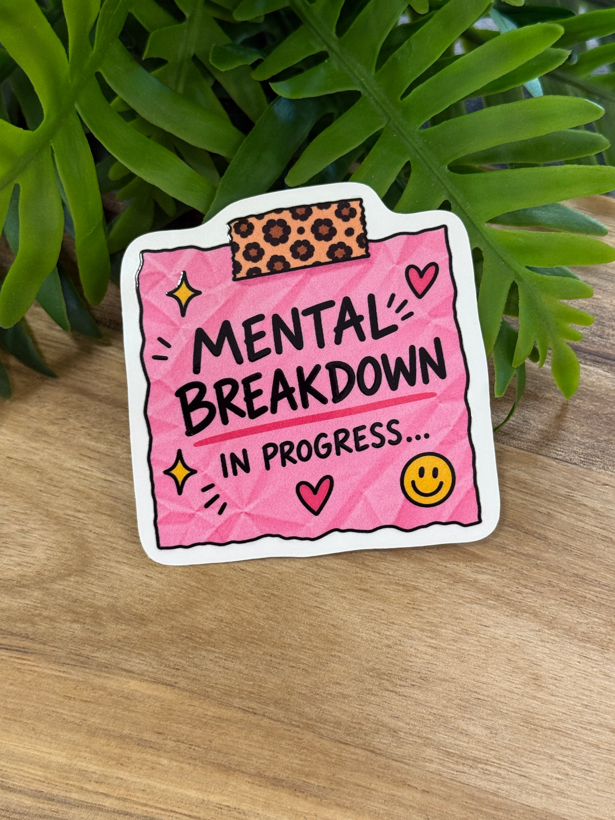 Pink Mental Breakdown in Progress sticker with leopard-print tape detail, hearts, yellow sparkles, and a smiley face