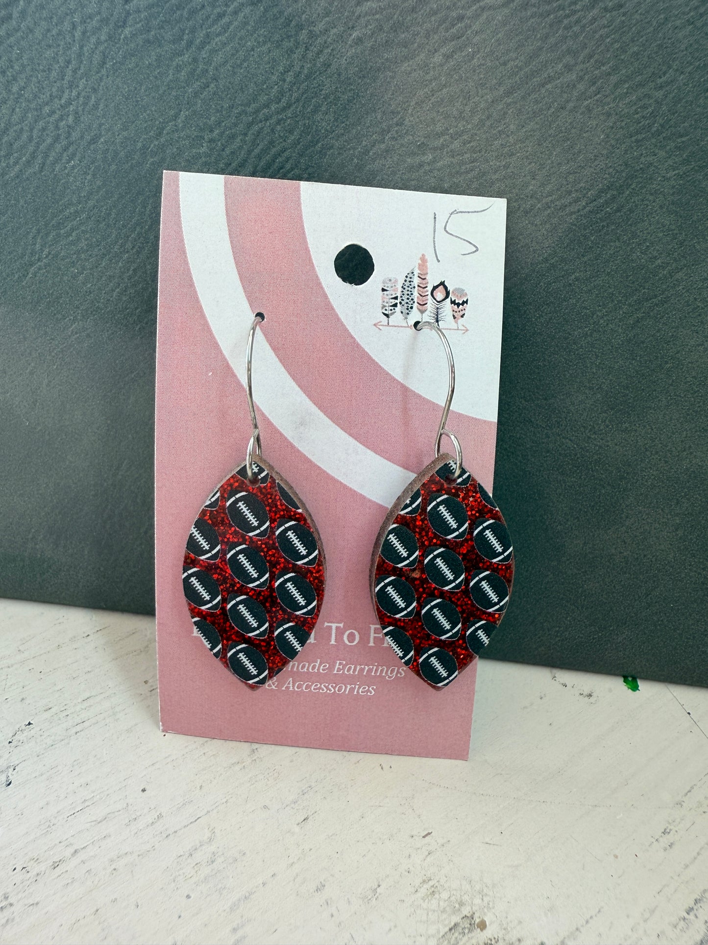 Football Scattered Print Dangle Earrings on Red Glitter