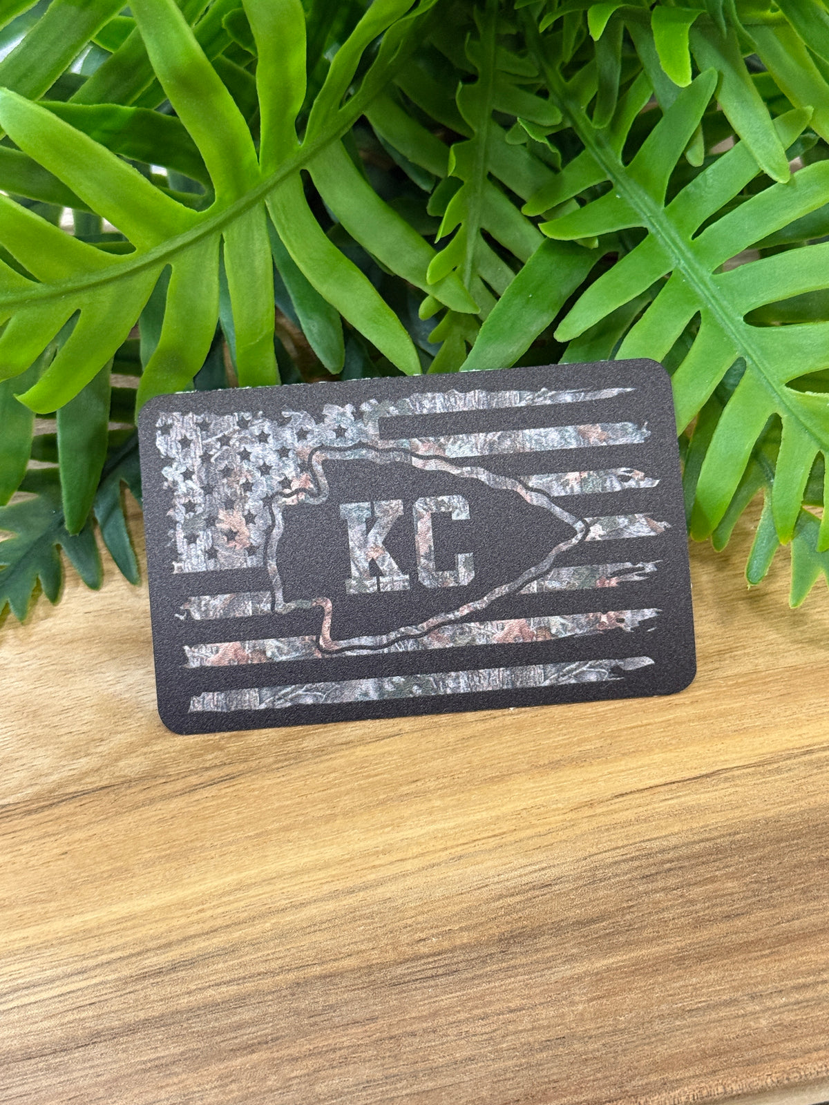 Black and gray distressed American flag sticker with a central arrowhead and KC lettering