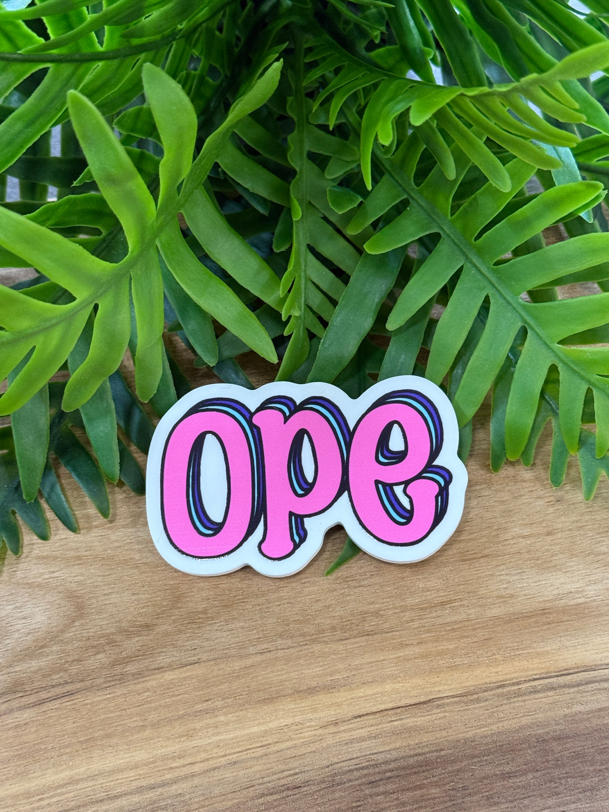 Ope acrylic magnet with pink lettering, dark outlines, blue and purple shadow accents, and a white border
