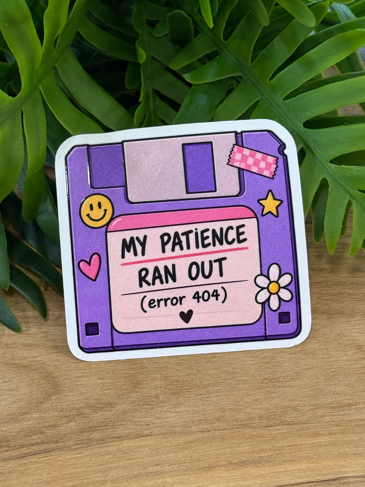 Purple floppy-disk vinyl sticker reading My Patience Ran Out error 404 with pink details, a smiley face, heart, star, and daisy